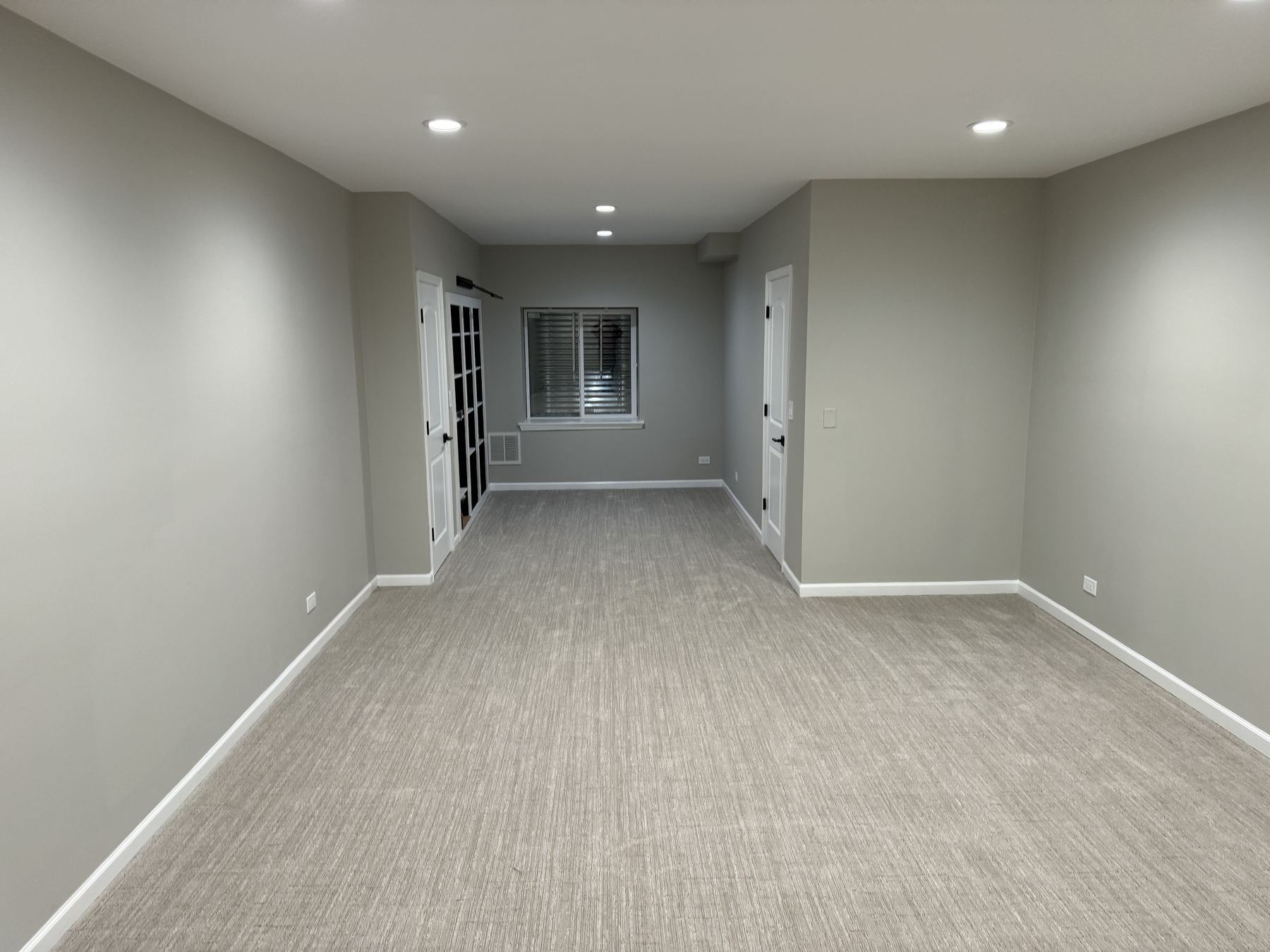Finished basement living space with carpet flooring