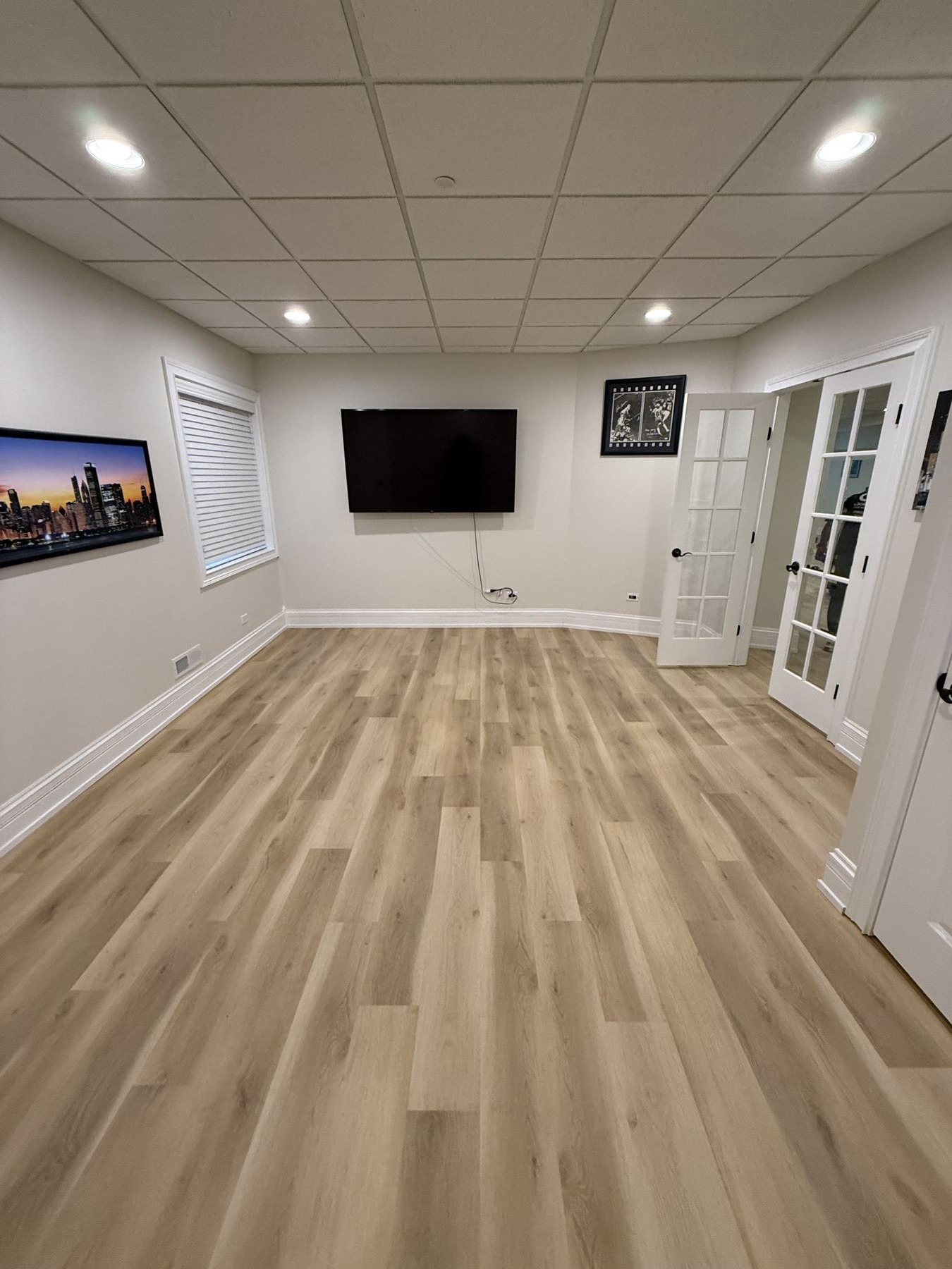 Finished basement rec room with luxury vinyl plank flooring