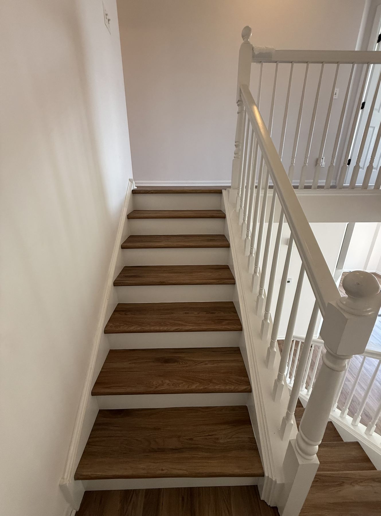 Refinished hardwood staircase installed by GFS Flooring Supply